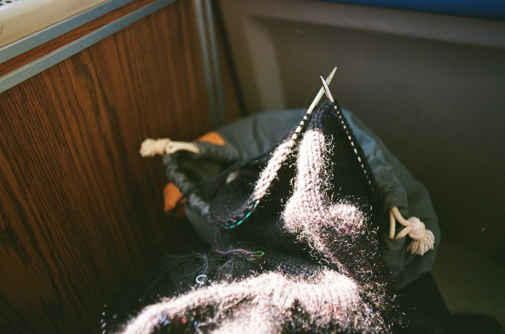 Sun on a sweater being knit, on a Metro North train