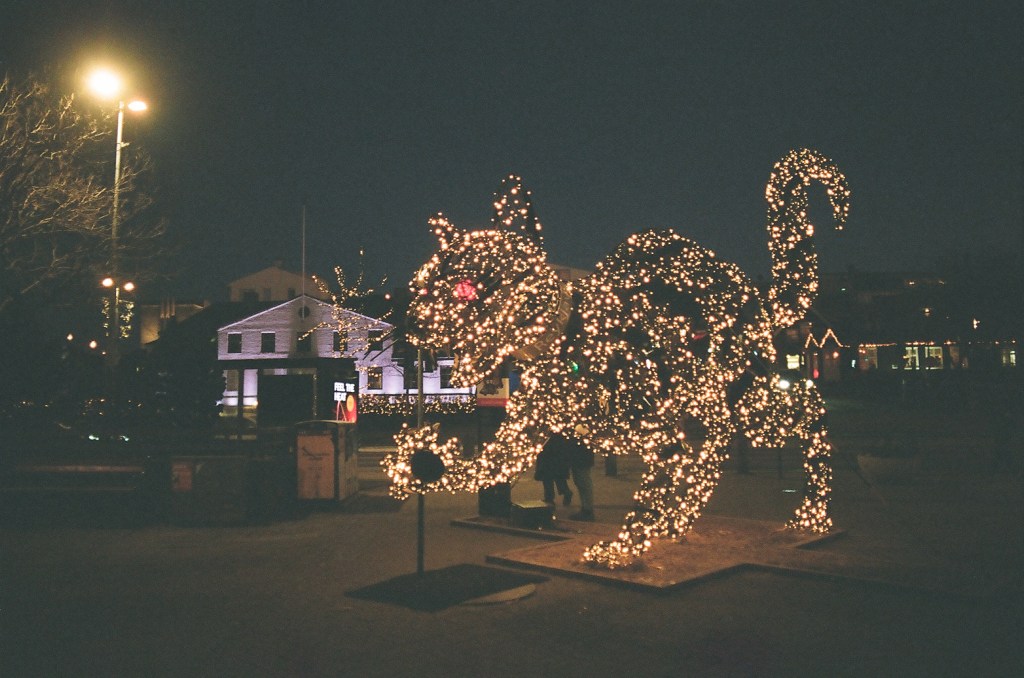 A yule cat light sculpture in Reykjavik at night.